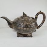 A highly decorative George III silver teapot having the whole body and spout embossed with flowers,