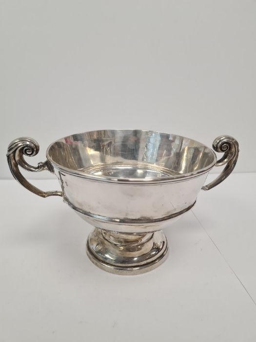 A silver trophy cup on a raised pedestal foot, the banded body holds two scroll handles and a hallma - Image 6 of 6