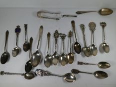 A quantity of silver spoons to include souvenir spoons. Various decorative spoons having ornate hand