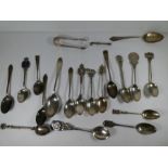 A quantity of silver spoons to include souvenir spoons. Various decorative spoons having ornate hand