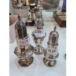 Three attractive silver sugar sifters of decorative design. Pierced lids. One standing on a raised p