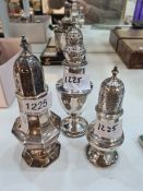 Three attractive silver sugar sifters of decorative design. Pierced lids. One standing on a raised p