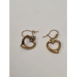 Pair of yellow metal drop earrings each suspended with a heart