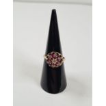 9ct yellow gold ruby and diamond chip raised cluster ring, size I, approx 2.6g, marked 375, maker W