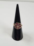 9ct yellow gold ruby and diamond chip raised cluster ring, size I, approx 2.6g, marked 375, maker W