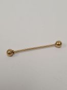 Unmarked yellow gold, probably 9ct Industrial piercing bar with bells, 1.64g approx, 4.5cm