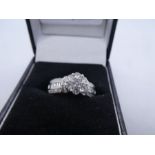 Contemporary diamond cluster ring, 7 0.10 carat diamonds form the flower head mounted in 18ct white
