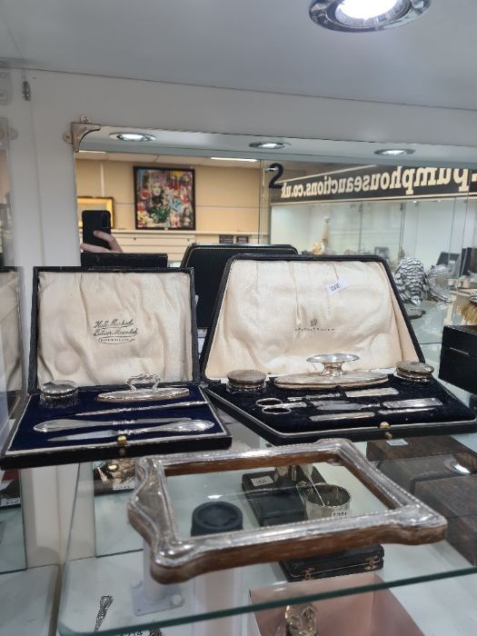 Two cased silver manicure sets, one by Elkington and Co Ltd., Birmingham 1927, also with a five piec