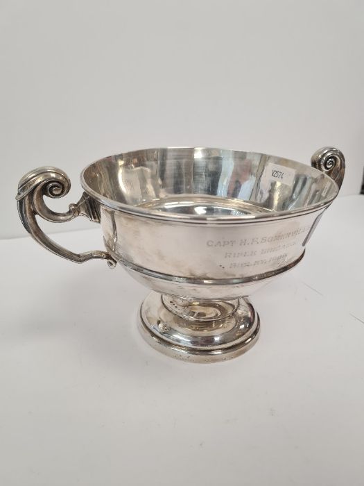 A silver trophy cup on a raised pedestal foot, the banded body holds two scroll handles and a hallma - Image 4 of 6