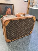 LOUIS VUITTON; a medium Louis Vuitton monogram suitcase, comes with leather bound corners, opening t