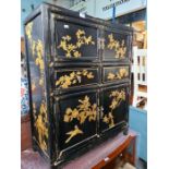 A Chinese export black lacquer cupboard the front and sides having gilt decoration of birds and tree