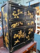 A Chinese export black lacquer cupboard the front and sides having gilt decoration of birds and tree