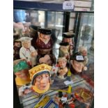 A shelf of Toby jugs and character jugs, mainly Royal Doulton (11)