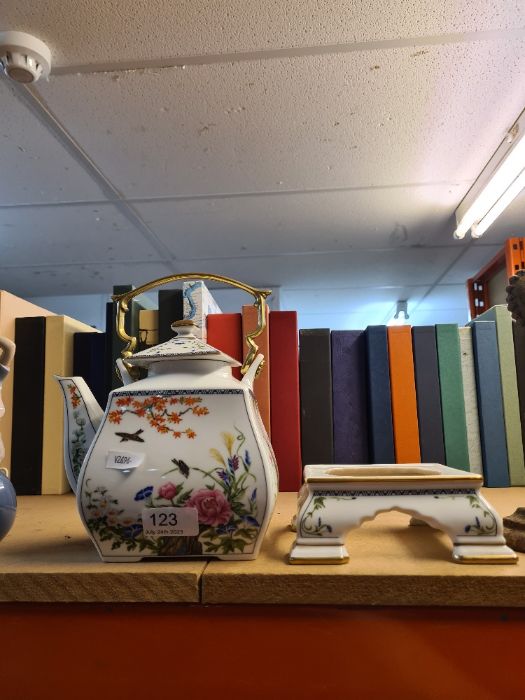 A Franklin Porcelain teapot on stand by Naoko Nobata decorated birds and flowers of the Orient