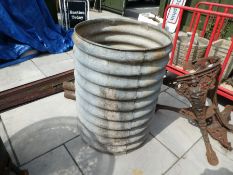 A vintage ribbed galvanised water but with brass tap