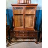 A Stag Minstrel dressing table, an oak cupboard having two doors and a mahogany glazed bookcase top