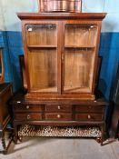 A Stag Minstrel dressing table, an oak cupboard having two doors and a mahogany glazed bookcase top