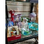 A shelf of glassware including coloured examples