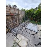 A set of 4 metal garden chairs having lattice design and a matching glass topped coffee table