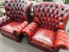A pair of Chesterfield oxblood colour armchairs with distressed look