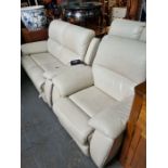 A pair of modern cream leather two seat sofas with reclining mechanisms, and a matching electrical r