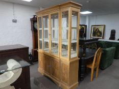 A modern lightwood display cabinet and base