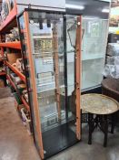 A modern glass display cabinet having 2 doors with mirror bakc