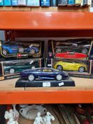 Two Burago 1:18 scale cars, two similar Maisto examples and one other