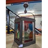 A metal and leaded glass ceiling light