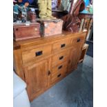 A contemporary oak sideboard having six drawers and cupboards, 143cms