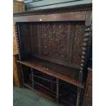A made up Oak bookcase/sideboard having 18th Century carved back decorated flowers, with similarly a