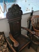 A high back with carved thistle decoration hall chair with arms