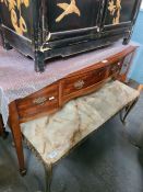 An antique mahogany bow fronted side table having three drawers on square legs