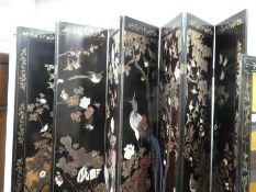 A large oriental solid wood room divider with carved relief of birds and flowers