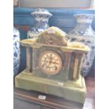 A Victorian onyx mantel clock having arched top with gilt metal mounts