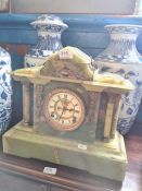 A Victorian onyx mantel clock having arched top with gilt metal mounts