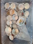 Two trays of commemorative mugs