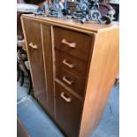 An EG G-Plan oak compactum having cupboards and drawers