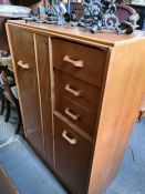 An EG G-Plan oak compactum having cupboards and drawers