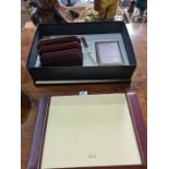 A Harrods maroon leather desk set in fitted box, including blotter and paper knife, etc