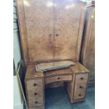 A 1930s walnut dressing table having 7 drawers having 7 drawers and a matching 2 door wardrobe