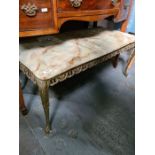 A vintage onyx oblong coffee table on gilt metal base