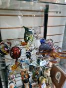 A shelf of glass to include an Octopus, a Mdina Stingray and paperweights