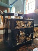 An Oriental lacquer three division box with signed lid decorated flowers, one other lacquer box and