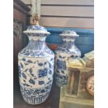 A pair of modern Chinese style blue and white vases and a pair of similar lamps (one lamp damaged to