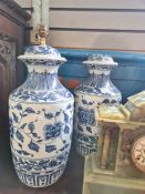 A pair of modern Chinese style blue and white vases and a pair of similar lamps (one lamp damaged to