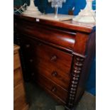 A Victorian mahogany chest having four long drawers on turned feet