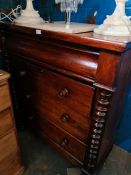 A Victorian mahogany chest having four long drawers on turned feet