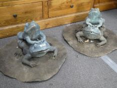A pair of cast metal water features depicting frogs on lillypads
