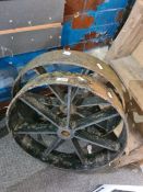 A pair of cast iron wheels having seven spokes each, 51cms